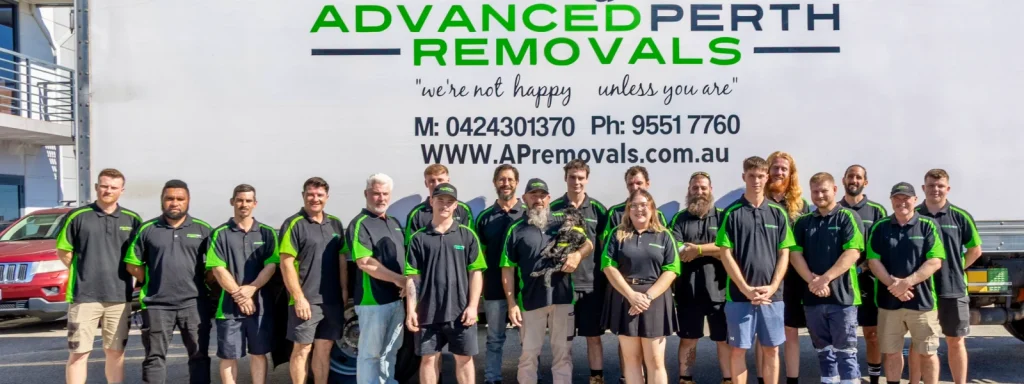 8 Ways to Save Money When Moving House in Perth - Advanced Perth Removals & Storage Group of removal company employees in black and green uniforms posing in front of a large 'Advanced Perth Removals' truck and branding.