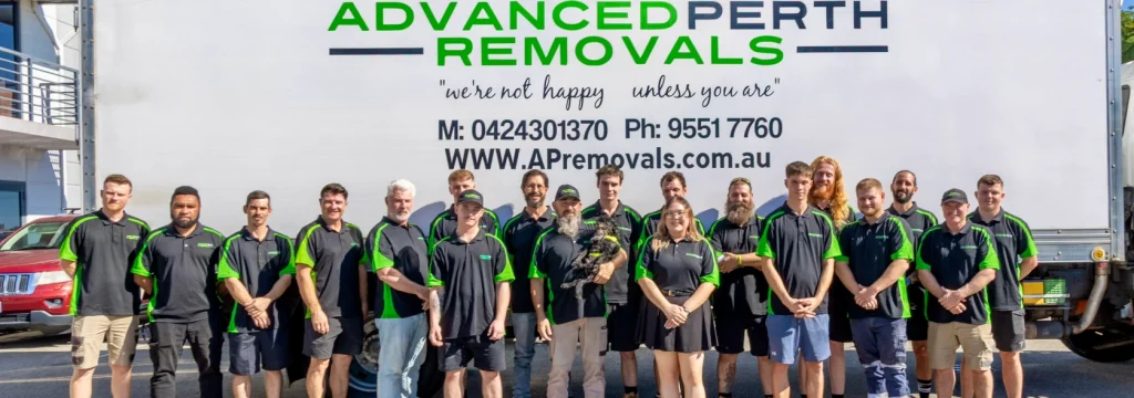 8 Ways to Save Money When Moving House in Perth - Advanced Perth Removals & Storage Group of removal company employees in black and green uniforms posing in front of a large 'Advanced Perth Removals' truck and branding.